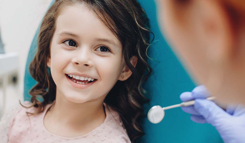 A young girl visits the dentist